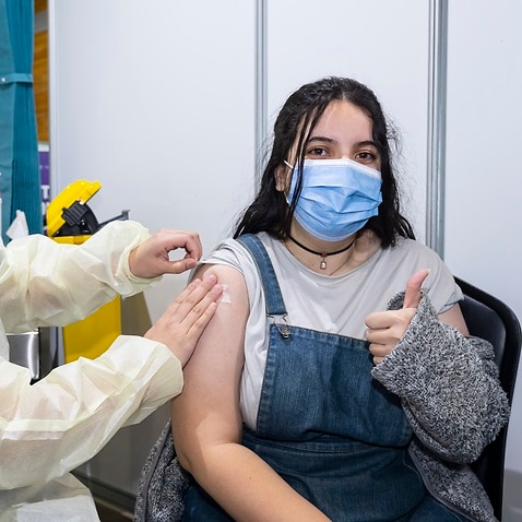 A year 12 student receives a vaccination at the Melbourne Museum