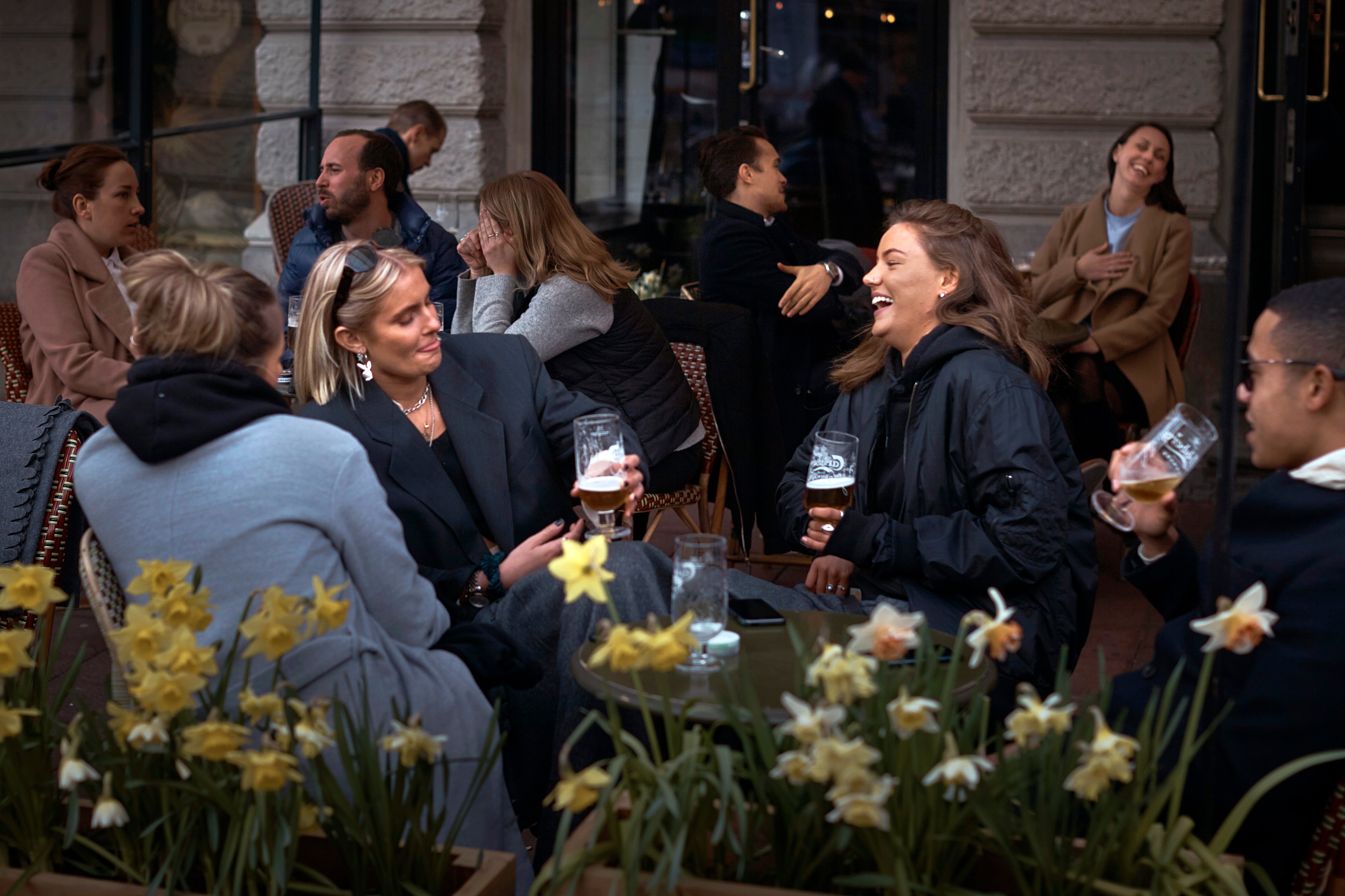 People chat and drink outside a bar in Stockholm, Sweden amid the coronavirus pandemic. People chat and drink outside a bar in Stockholm, Sweden amid the coronavirus pandemic.