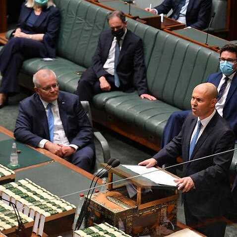 Prime Minister Scott Morrison looks on as Treasurer Josh Frydenberg hands down his fourth budget in the House of Representatives at Parliament House