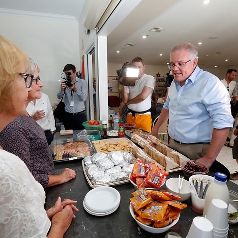 Prime Minister Scott Morrison speaks with volunteers while visiting the relief centre in Lobethal, South Australia, Tuesday, December 24, 2019. The Prime Minister is touring fire affected areas in South Australia. (AAP Image/Kelly Barnes) NO ARCHIVING