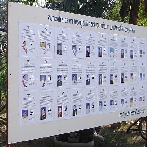 Image of a board containing Thai political candidates' details.