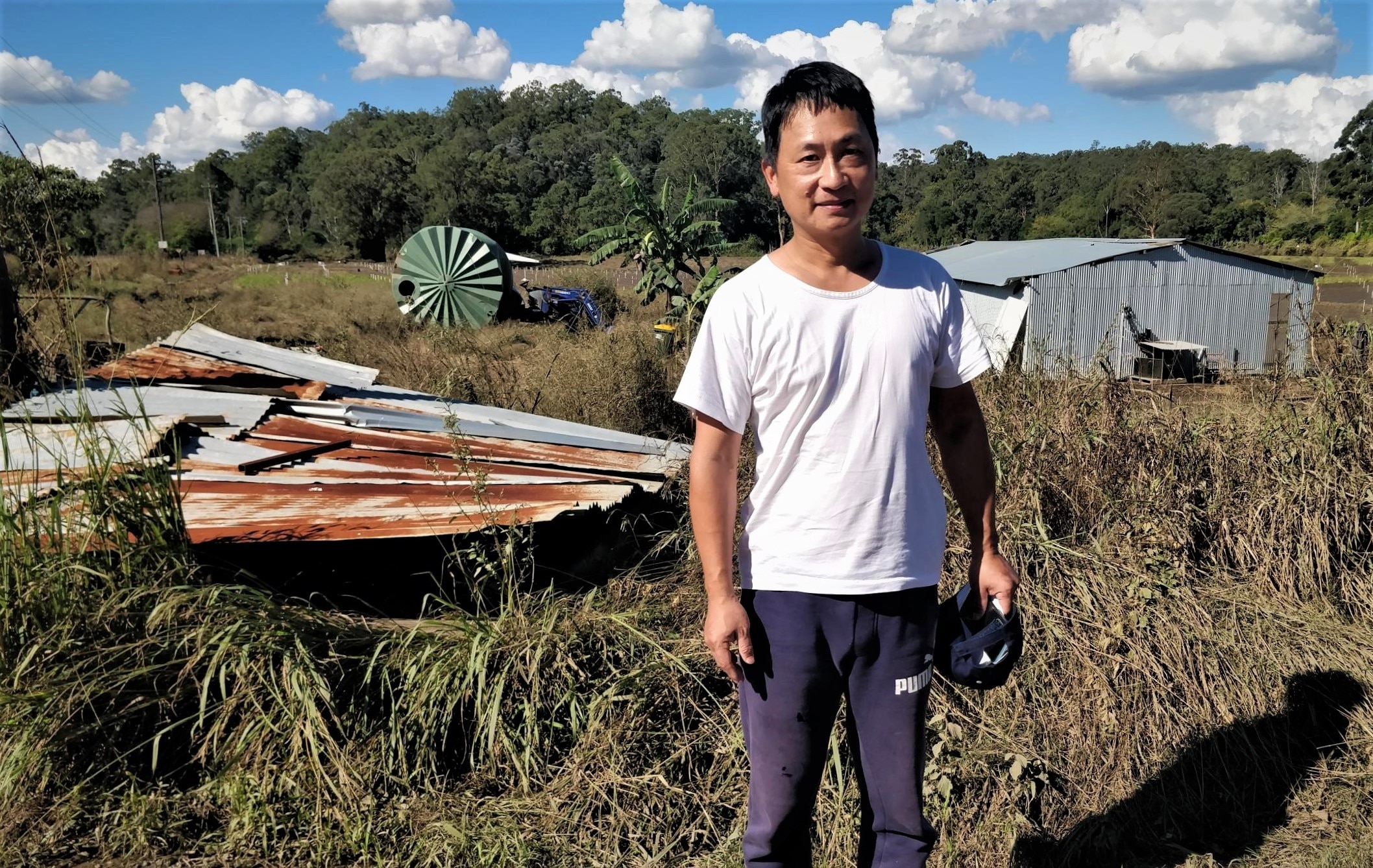 Shi Zhuang (Ashton) at his flood affected farm in Sackville, NSW.