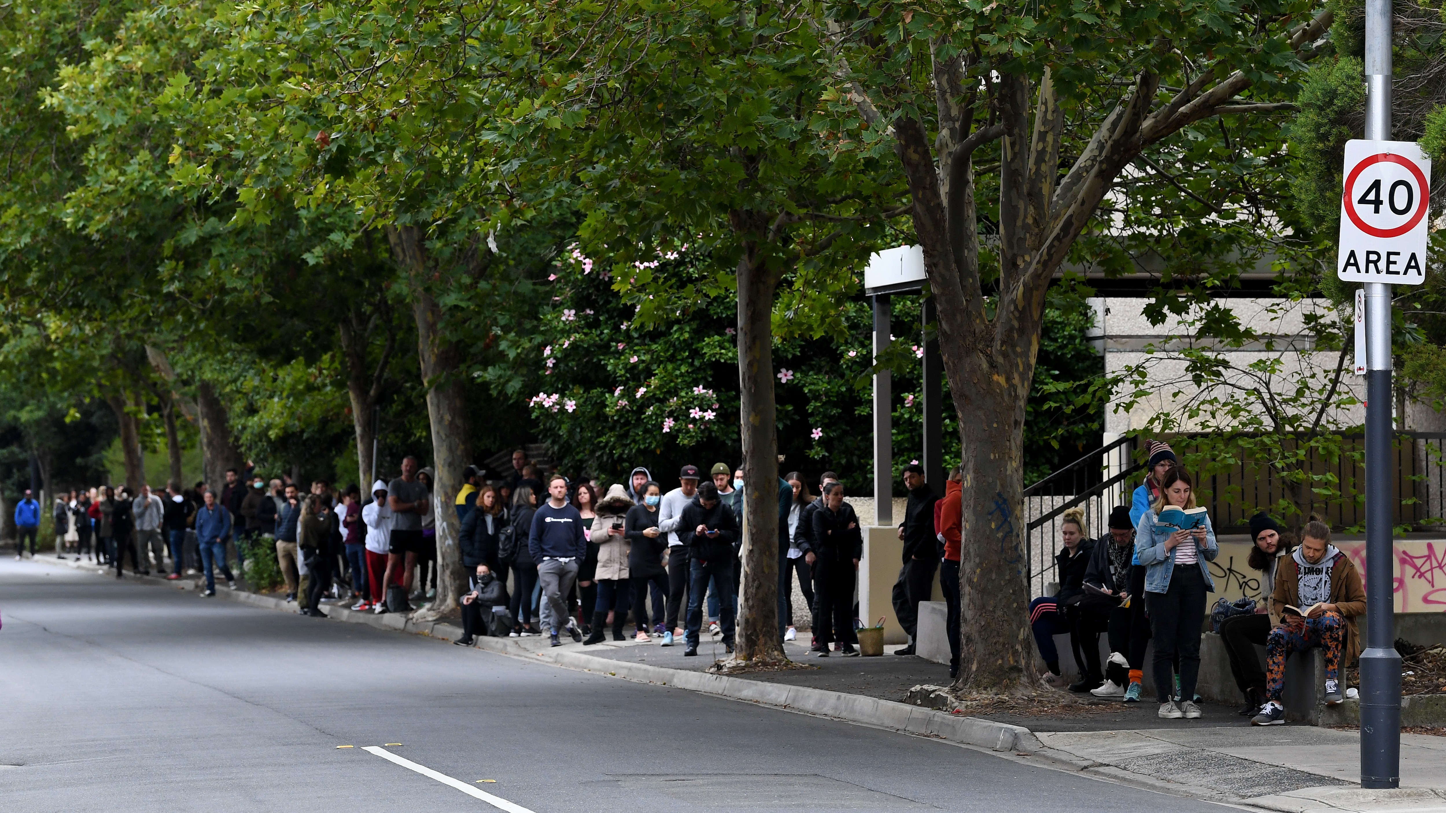 People are seen waiting in line at the Prahran Centrelink office in Melbourne.