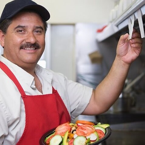 Portrait of man working in restaurant kitchen