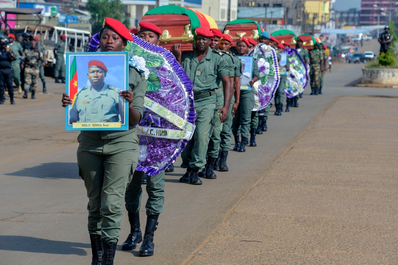 Soldiers carry the coffins of the four soldiers killed in the violence that erupted in the northwest and southwest Regions of Cameroon in 2017.