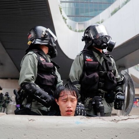 Police detain a protester in Hong Kong.