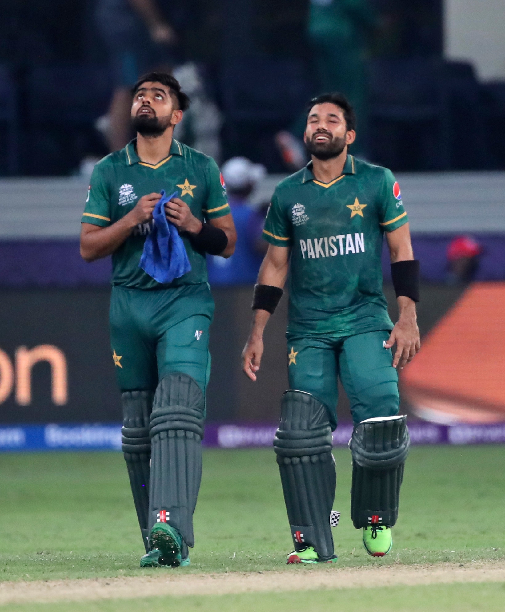 Pakistan's cricket captain Babar Azam, left, and Mohammad Rizwan celebrate after their team won the Cricket Twenty20 World Cup match between India and Pakistan in Dubai, UAE, Sunday, Oct. 24, 2021. (AP Photo/Aijaz Rahi)