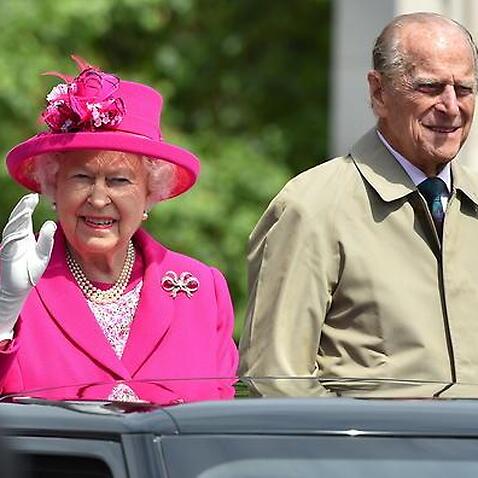 Queen Elizabeth II and the Duke of Edinburgh make their way down The Mall, during the Patron's Lunch in honour of the Queen's 90th birthday. (AAP)