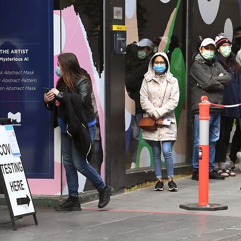 People queue at a Covid-19 coronavirus testing station in Melbourne on 12 August, 2021. 