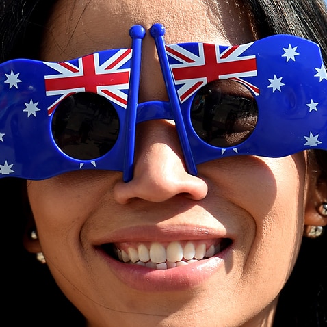 A woman with Australian flags on her sunglasses