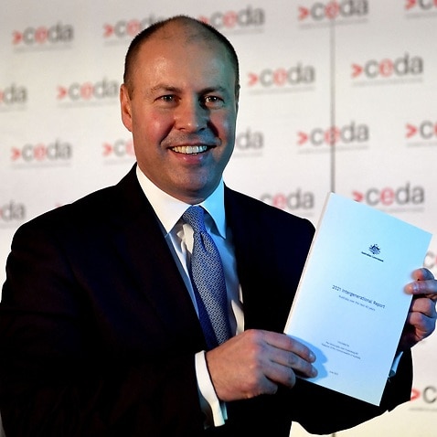 Australian treasurer Josh Frydenberg holds a copy of the 2021 Intergenerational Report in Melbourne on June 28, 2021. (Photo by William WEST / AFP) (Photo by WILLIAM WEST/AFP via Getty Images)