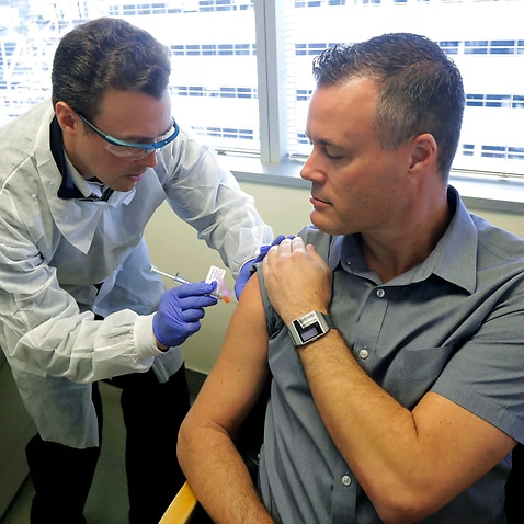 Pharmacist Michael Witte gives Neal Browning a shot