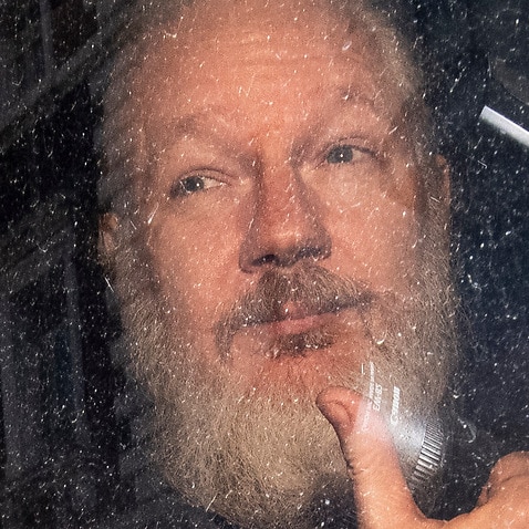 Wikileaks co-founder Julian Assange, in a prison van, as he leaves Southwark Crown Court in London, Britain.