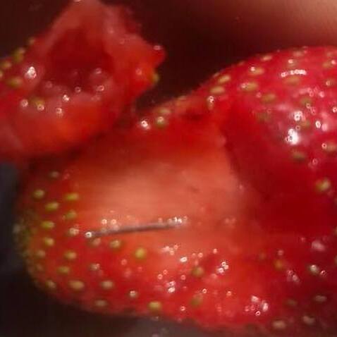 Image of a strawberry with sewing needle inside from facebook