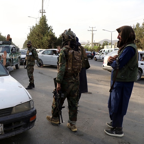 Taliban fighters stand guard at a checkpoint near the gate of Hamid Karzai international Airport in Kabul, Afghanistan, Saturday, August 28, 2021.