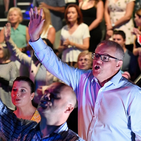 Scott Morrison sings during an Easter Sunday service at his Horizon Church at Sutherland in Sydney, Sunday, April 21, 2019