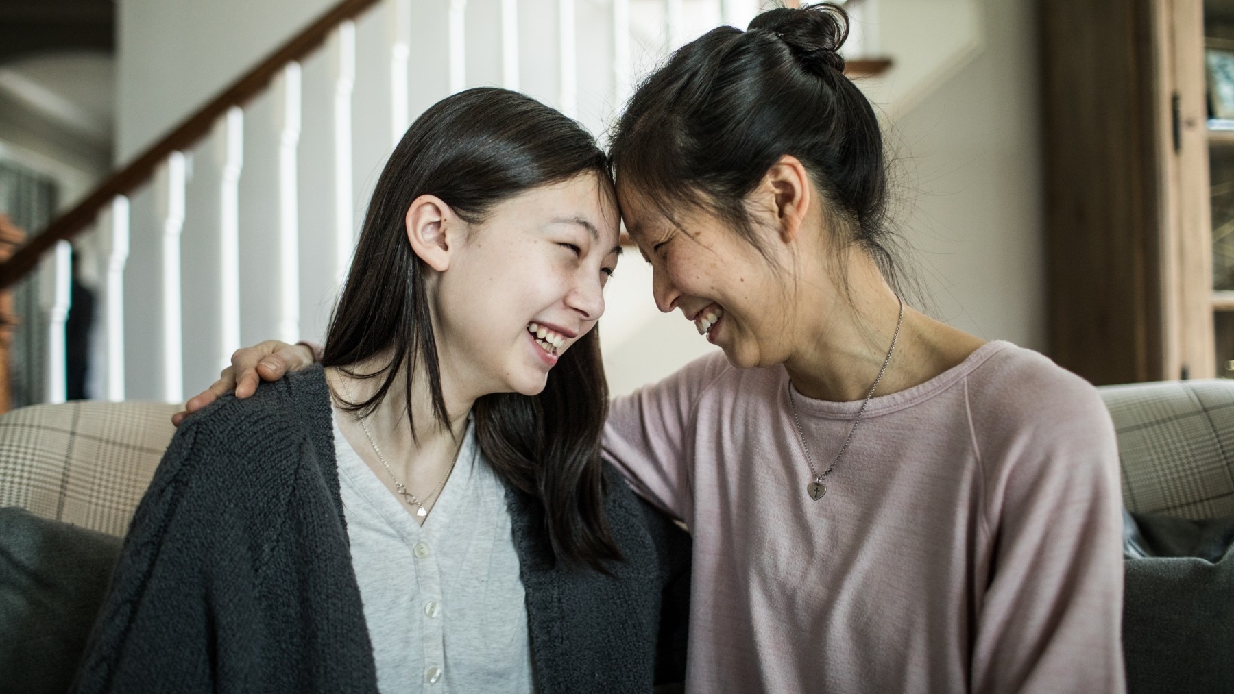 Asian background Mother and teenage daughter talking at home