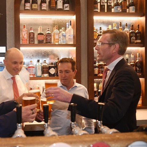 NSW Premier Dominic Perrottet (right) and NSW Deputy Premier Paul Toole (2nd from right) and Treasurer Matt Kean toast with a beer at Watson’s Pub in Sydney