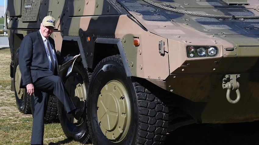 A file image of Queensland Senator Ian Macdonald with a Boxer CRV tank
