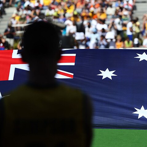 File, Melbourne, December 2012, The Australian flag held up during the Australian National Anthem before a cricket match.
