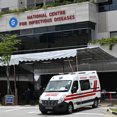 An ambulance leaves the National Centre for Infectious Diseases, where patients suffering from the COVID-19 novel coronavirus are being cared for, in Singapore on April 3, 2020. (Photo by Roslan RAHMAN / AFP) (Photo by ROSLAN RAHMAN/AFP via Getty Images)