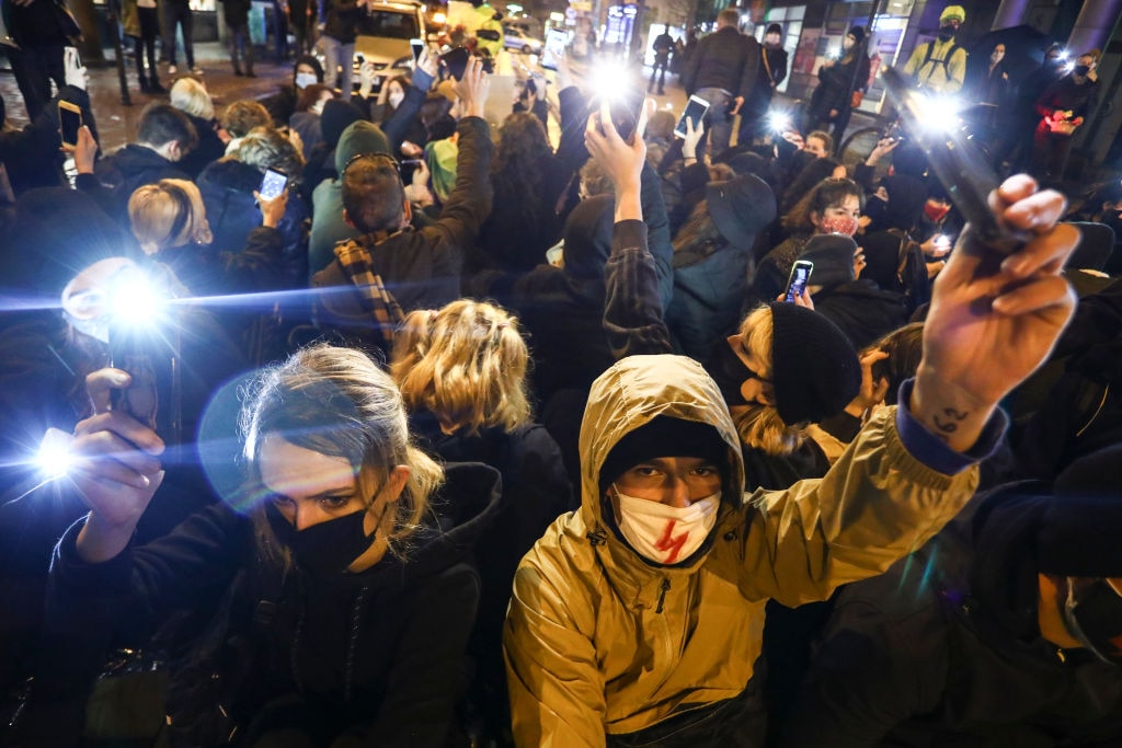 People demonstrate against restrictions on abortion law by blocking traffic in the centre of Krakow, Poland on 2 November. 