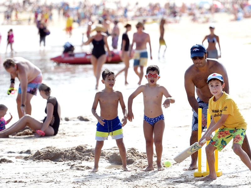 Children play cricket on Bondi Beach