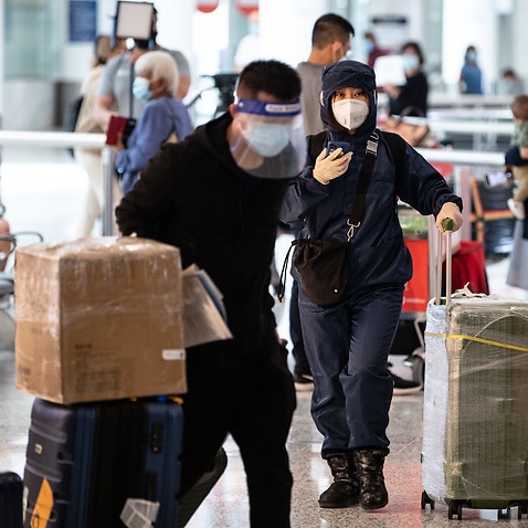 People wearing PPE arriving at Sydney International Airport in Sydney.
