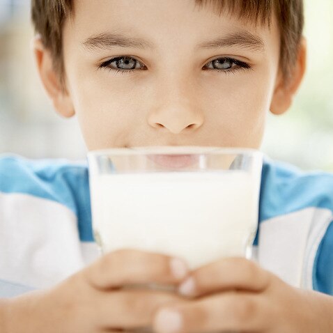 A young boy with a glass of milk