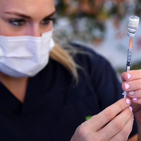 Nurse preparing a COVID-19 vaccine.