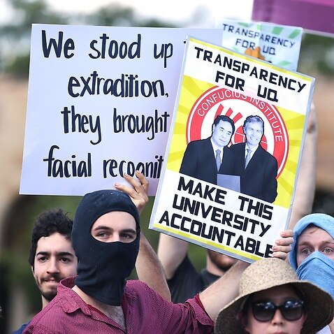 Students hold placards during a protest at the University of Queensland in Brisbane.