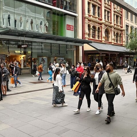 Shoppers walk around Pitt Street Mall in Sydney