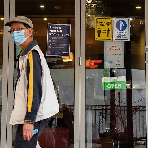 COVID-19 safety signs are placed on a restaurant door in Merrylands, Sydney, Wednesday, August 25, 2021. 