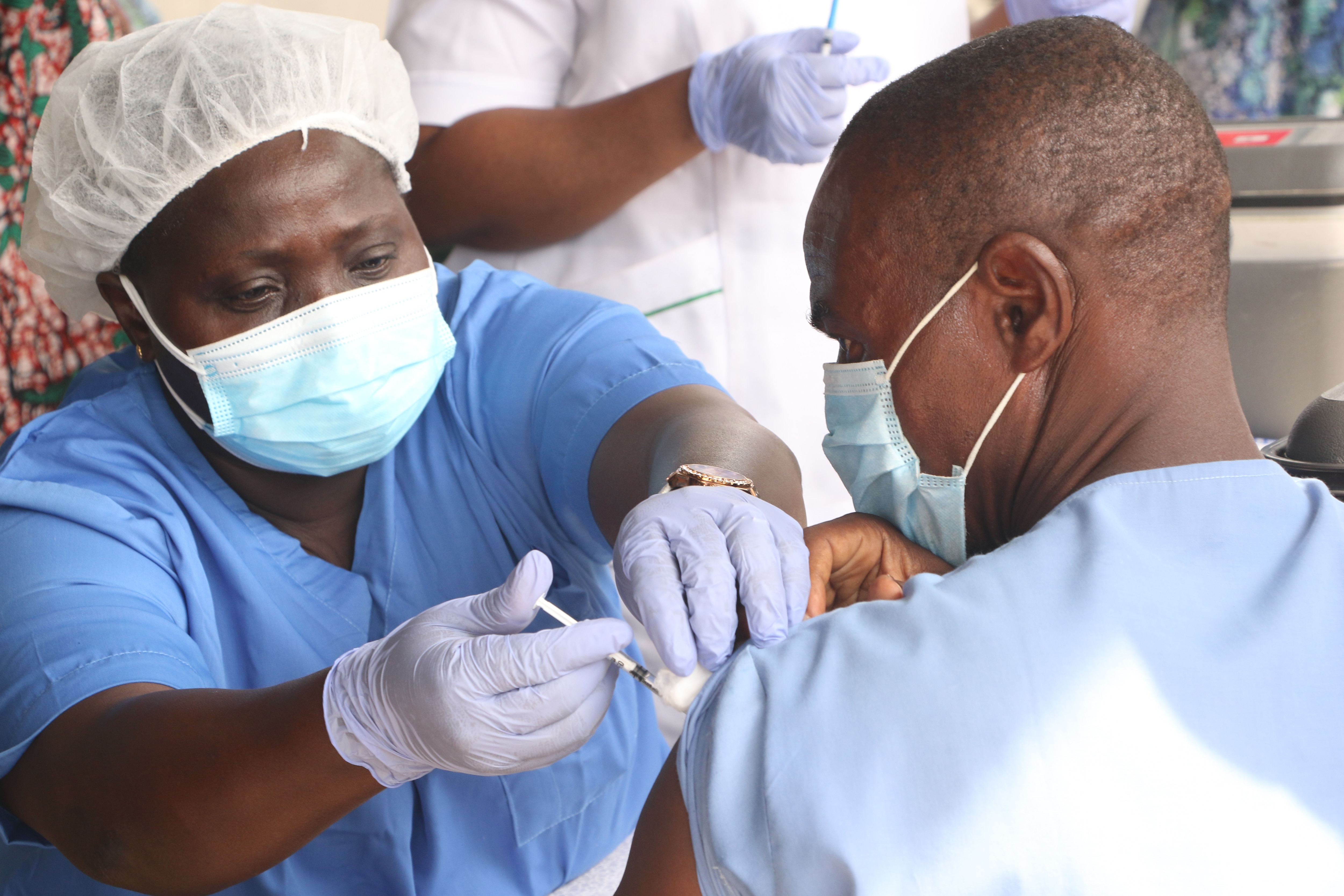 A health worker administers a COVID-19 vaccine in Nigeria.