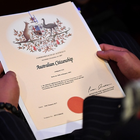 An Australian citizenship recipient holds his certificate during a citizenship ceremony on Australia Day in Brisbane, Thursday, Jan. 26, 2017. (AAP Image/Dan Peled) NO ARCHIVING