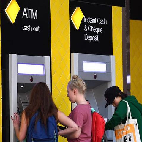 Customers use a Commonwealth Bank (CBA) ATM in Brisbane