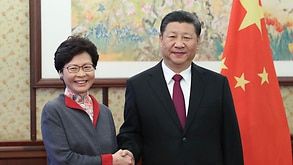 Hong Kong Chief Executive Carrie Lam, left, shakes hands with Chinese President Xi Jinping in Beijing, Friday, Dec. 15, 2017.