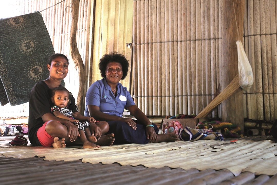 Village health volunteer Patricia (right) with mother Judy, whose baby she helped deliver. 