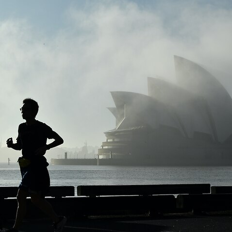 A man running past the Sydney Opera House 