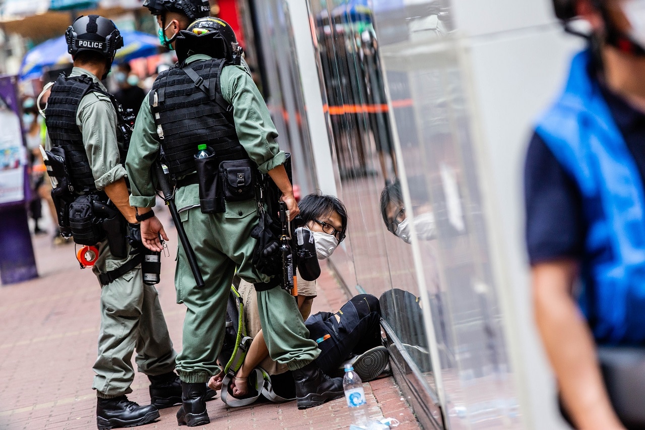 Riot police officers arrest a protester in Hong Kong.