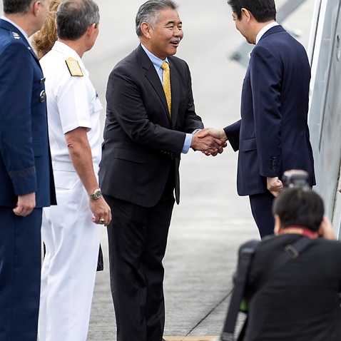 Hawaii Gov. David Ige greets Japanese Prime Minster Shinzo Abe at Joint Base Pearl Harbor Hickam, Monday, Dec. 26, 2016, in Honolulu.  