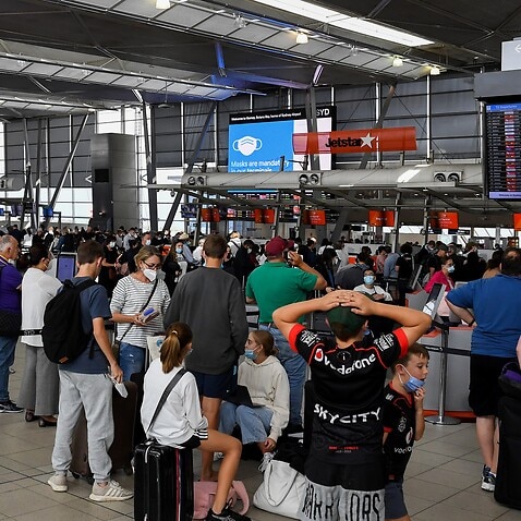 Queues of people are seen at the Virgin and Jetstar departure terminal at at Sydney Domestic Airport in Sydney, Wednesday, April 13, 2022. (AAP Image/Bianca De Marchi) NO ARCHIVING
