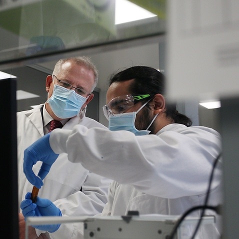 Prime Minister Scott Morrison meets with team member Gaby Atencio during a visit to AstraZeneca laboratories in Macquarie Park, Sydney on 19 August, 2020. 