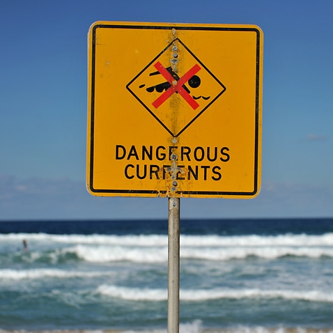 A sign warning of dangerous currents alerts