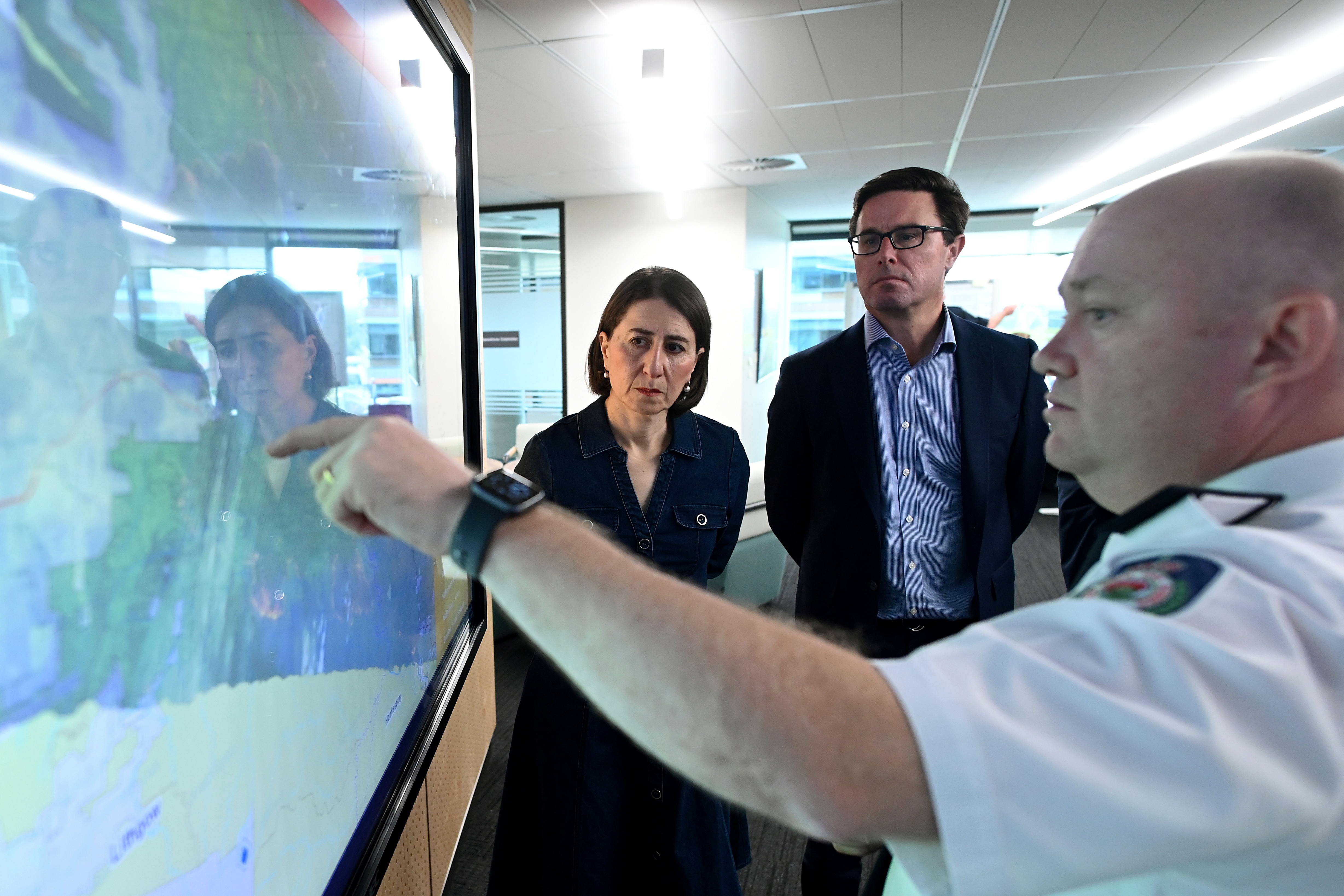 NSW Premier Gladys Berejiklian (left) and Federal Minister for Water Resources David Littleproud are briefed by Commissioner NSW RFS Shane Fitzsimmons.