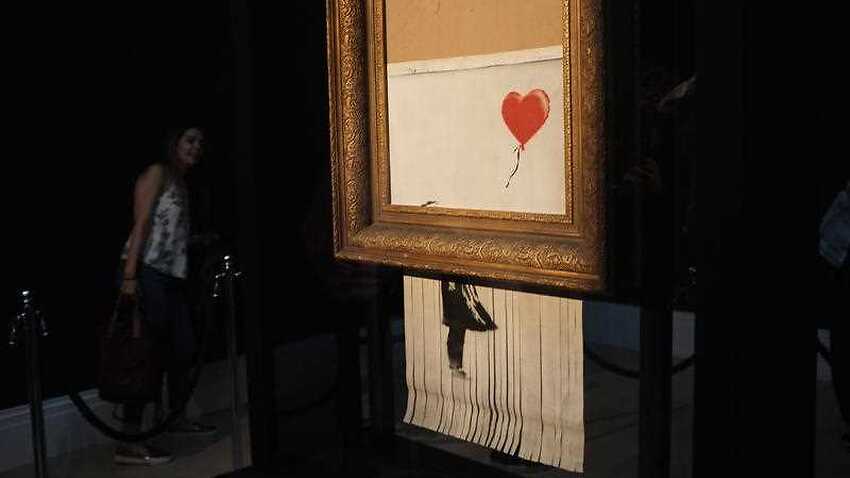 Banksy implies 'Girl with Balloon' incomplete shredding a glitch | SBS News