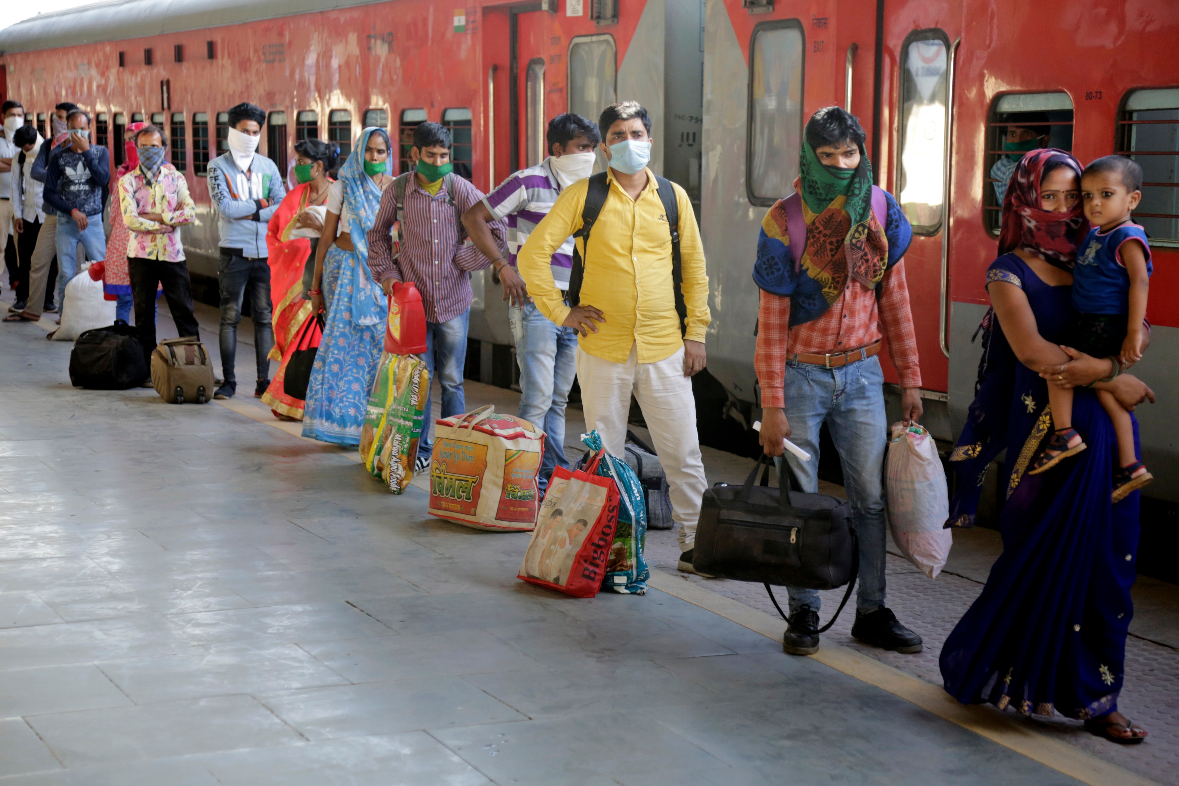 Indian migrated workers stands in queue to board a special train at a railway station in Ahmedabad, India. Indian migrated workers stands in queue to board a special train at a railway station in Ahmedabad, India.