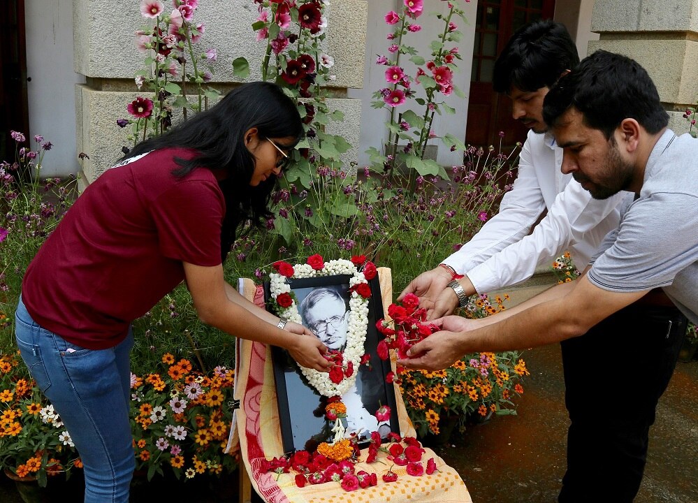 Faculty members of a Indian Institute of Science (IISC) lay flowers in honour of a British physicist on conference of his passing.