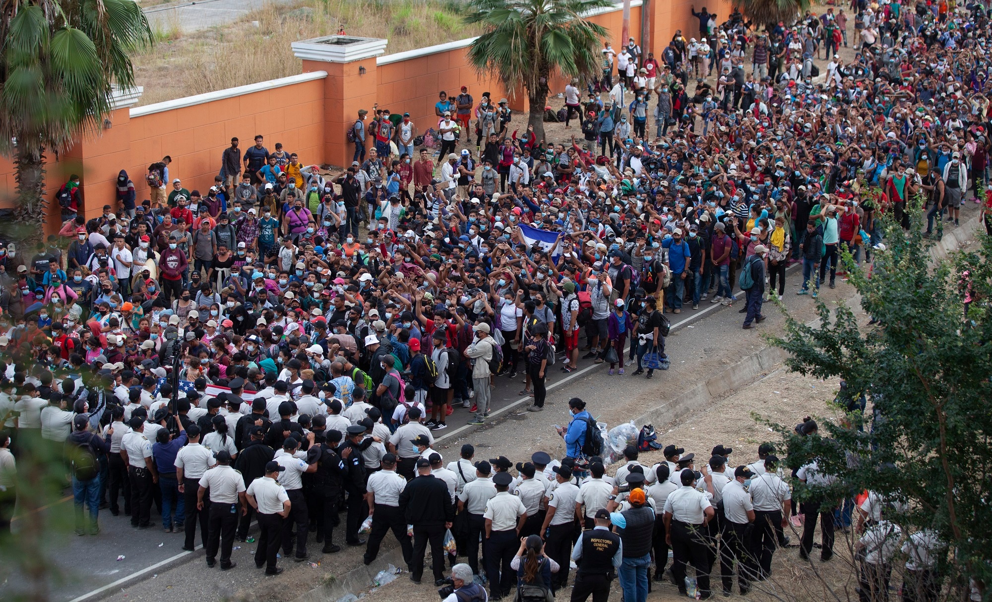 Honduran asylum seekers gather in front of a police roadblock at a highway in Vado Hondo, Guatemala.