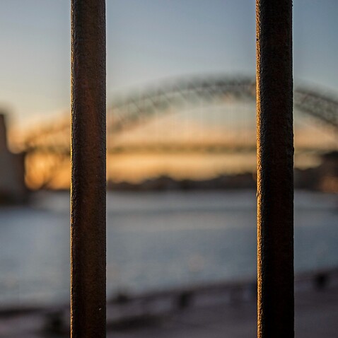 Sydney Harbour Bridge view behind bars